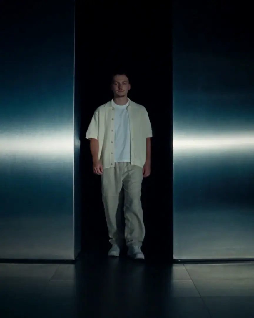 Finn standing in a beam of light