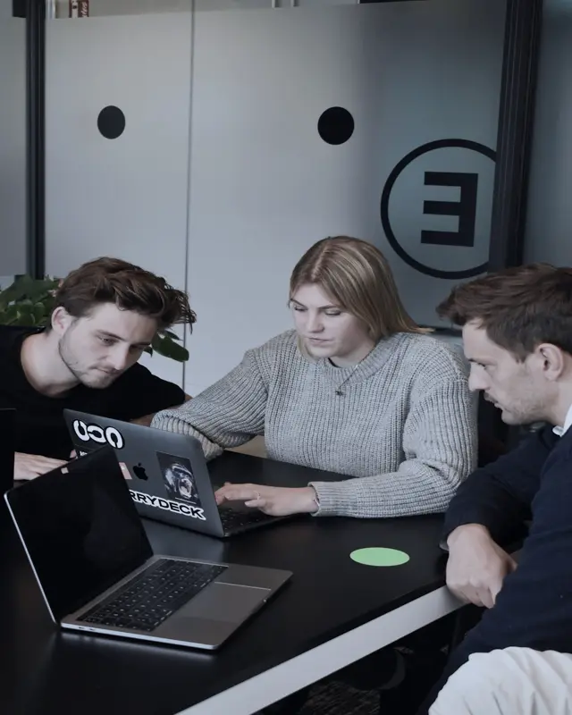 An agency team working together on laptops