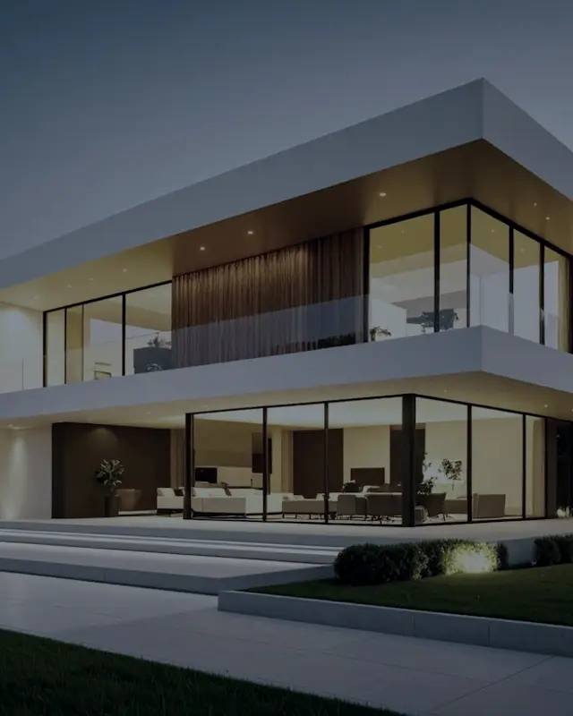 A modern house with large windows at dusk